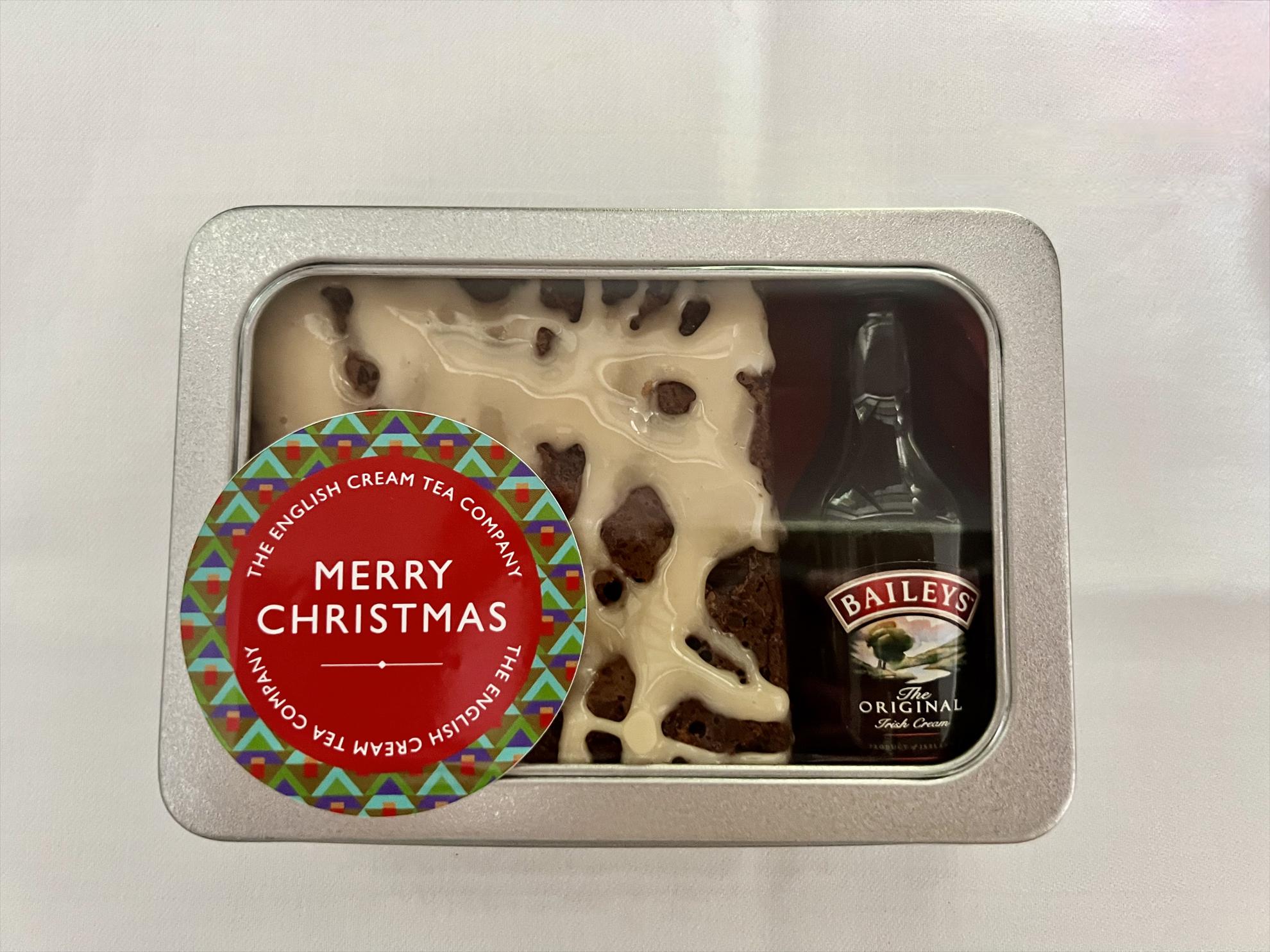 Festive Gift tin showing Baileys Chocolate Brownie with small bottle of Baileys