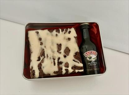 Open Gift tin showing Baileys Chocolate Brownie with small bottle of Baileys