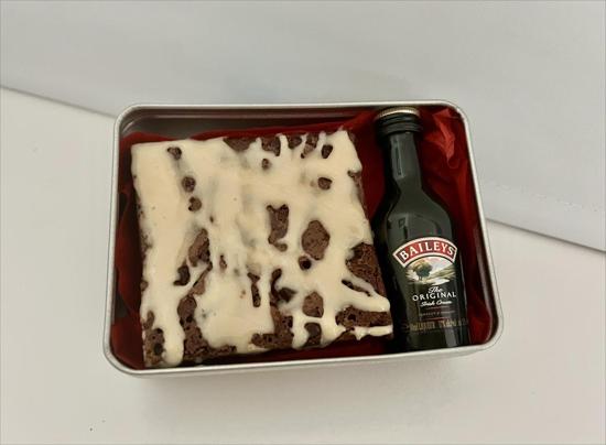 Open Gift tin showing Baileys Chocolate Brownie with small bottle of Baileys